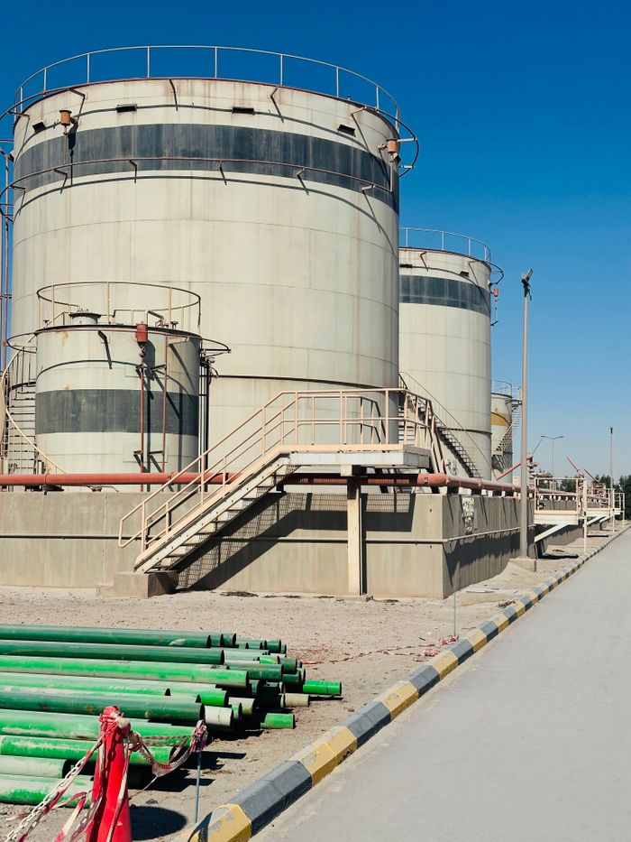 Storage tanks in Saudi Arabia with clear blue sky, showcasing industrial infrastructure confidently.